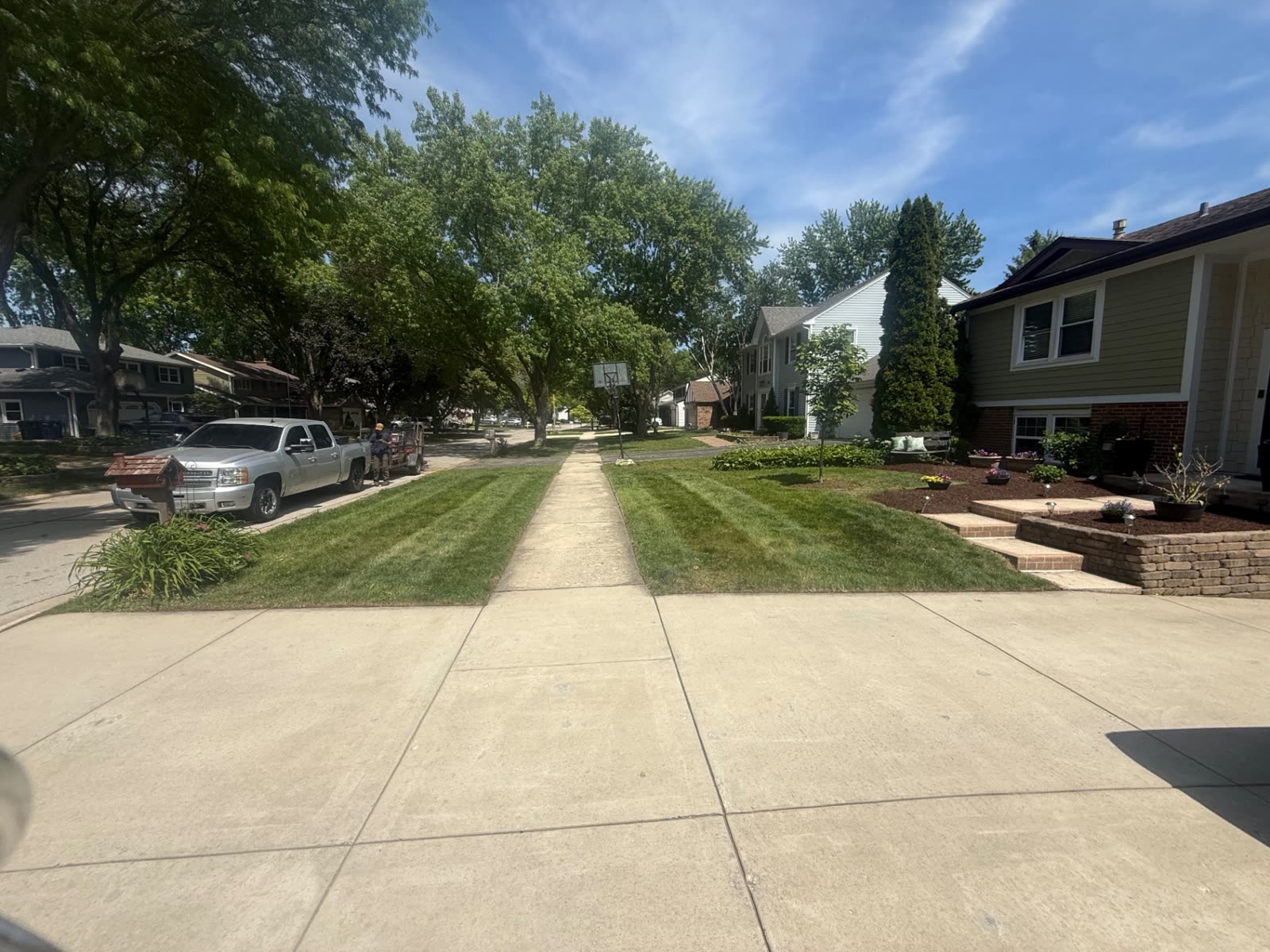 Finished front yard with beds, walkway and striped lawn