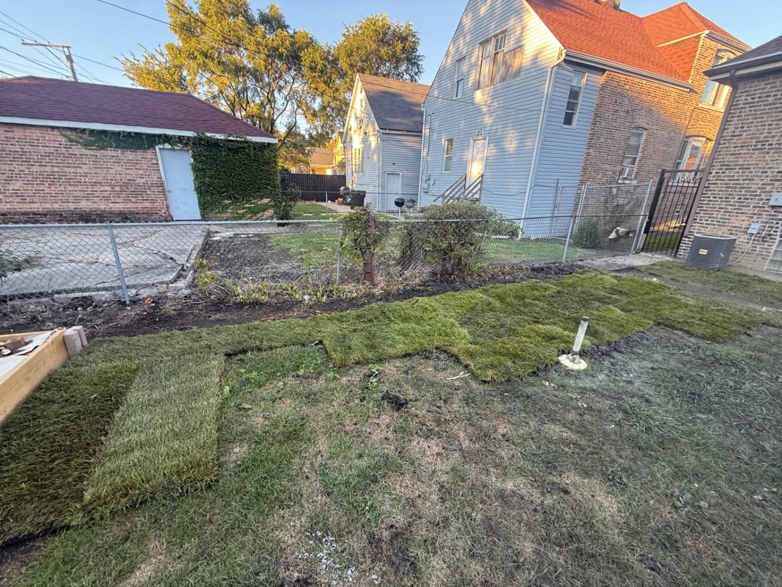 Sod installation along a backyard bed