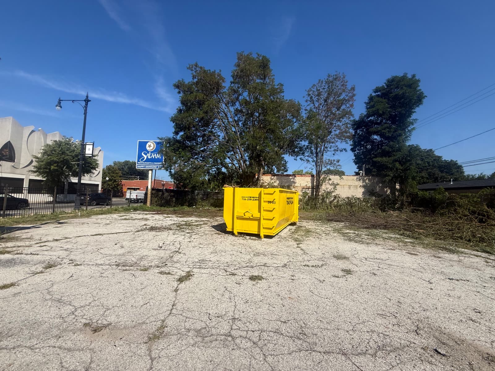 Lot clearing with dumpster on site