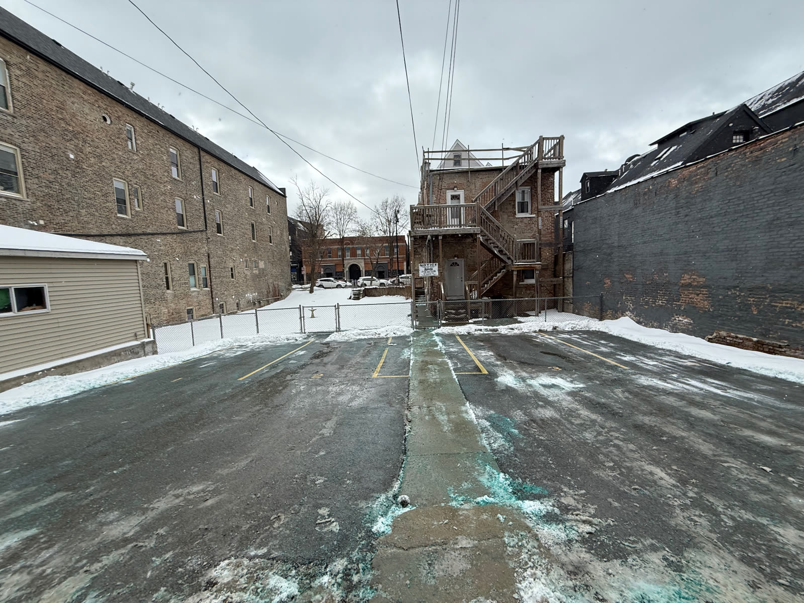Snow-covered lot between apartment buildings