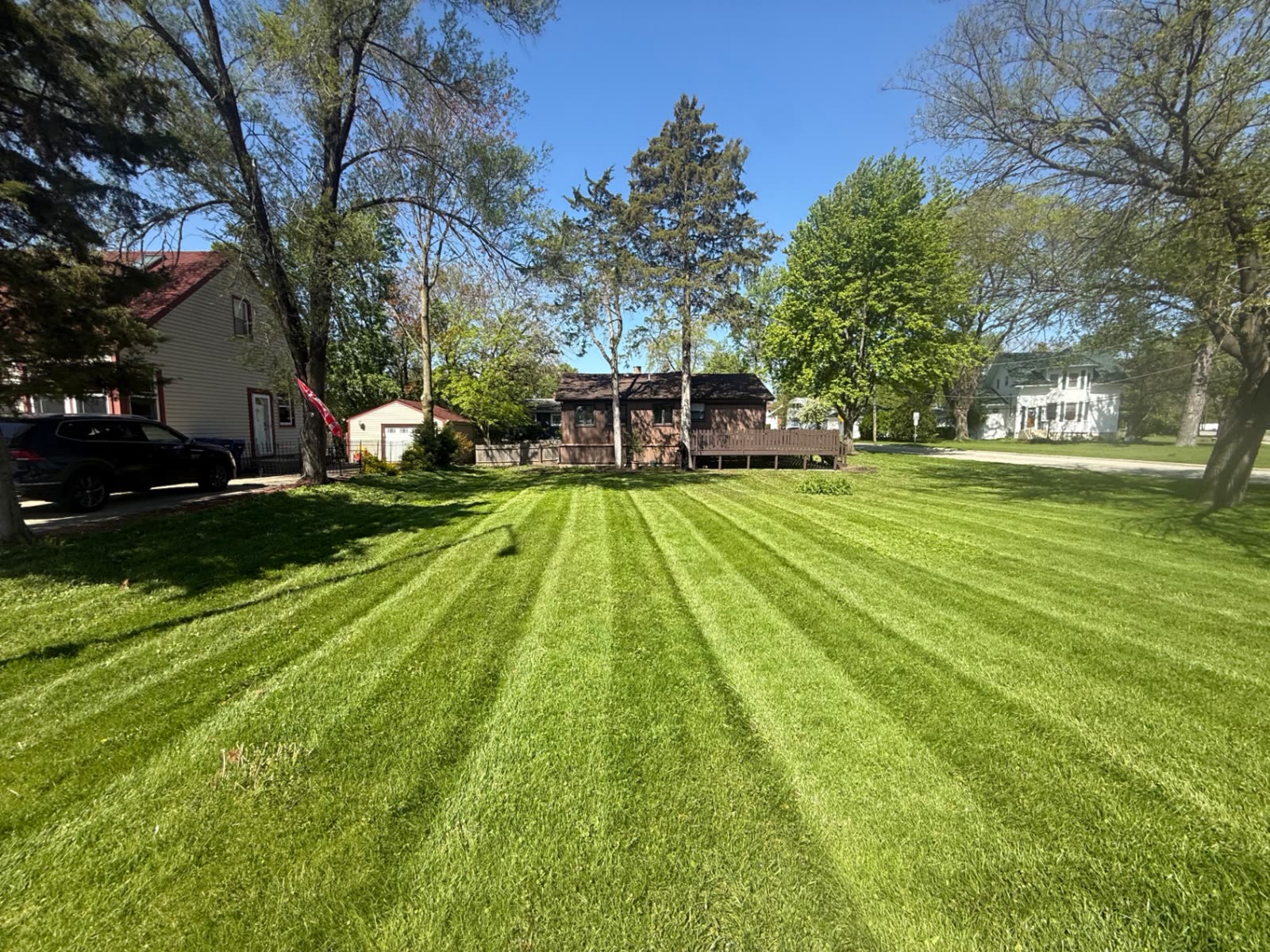 Large residential lawn with diagonal mowing stripes